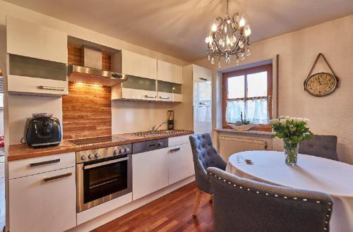 a kitchen with a table and a dining room at Ferienwohnung Fritz in Bodenmais