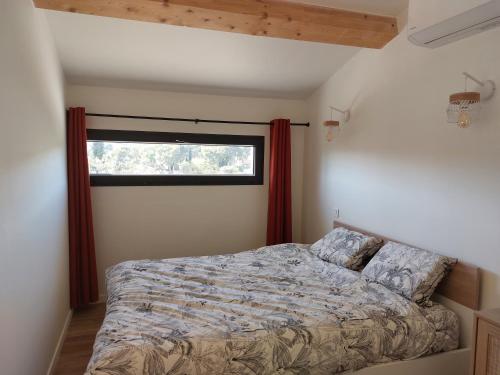 a bedroom with a bed in front of a window at La Belle de Cassis in Cassis