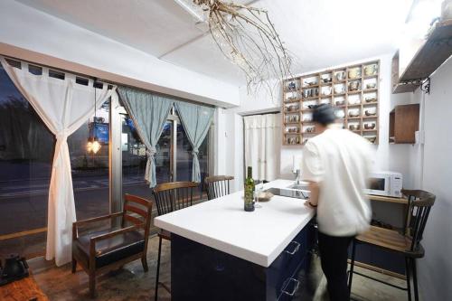 a person standing at a counter in a kitchen at Spring Day in Jeonju