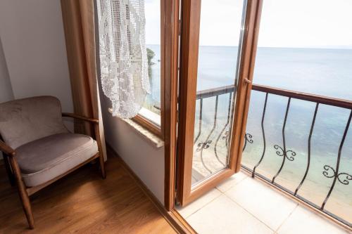 a room with a chair and a large window at Sinop Antik Otel in Sinop