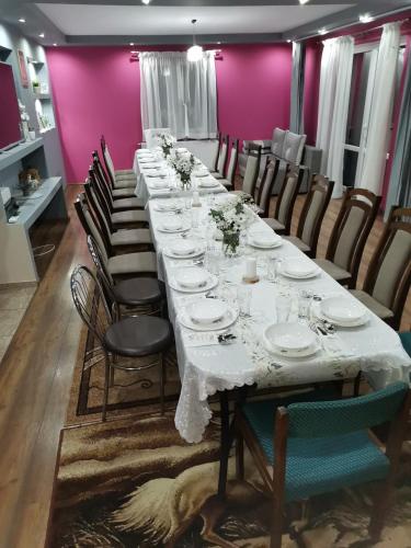 a long table in a room with chairs at Apartament u Wioli in Okleśna