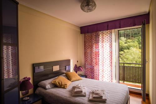 a bedroom with a bed and a large window at Casa con terraza para 4 personas en Plentzia in Mendiondo