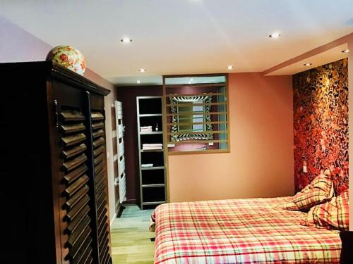 a bedroom with a bed and a wine cellar at Le Cerf Enchanteur in Thyez