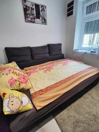 a bed with pillows on it in a bedroom at Sétány Apartman in Balatonalmádi
