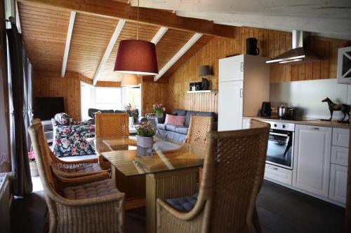 a kitchen and living room with a table and chairs at Hotel Hof Kirchhorst in Groß Wittensee