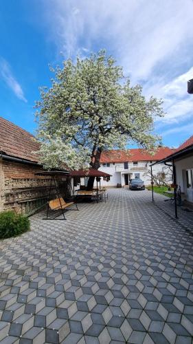 a tree in the middle of a courtyard at Casa Sommer in Petreşti