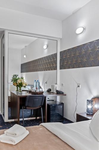 a kitchen with a table and a mirror in a room at Hotel Charter Otopeni in Otopeni