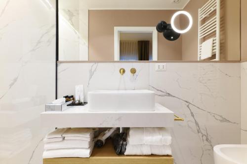 a bathroom with a white sink and a mirror at PRESTIGE BOUTIQUE APARTHOTEL - Piazza Duomo View in Milan