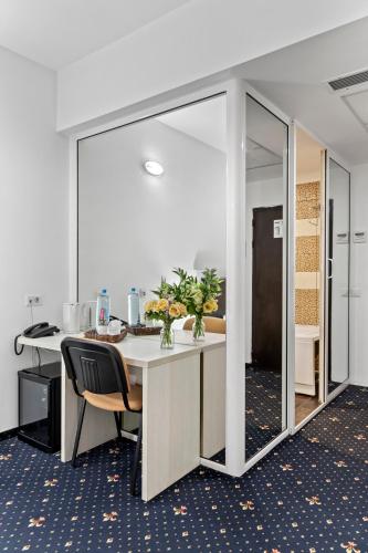 an office with a desk with chairs and a mirror at Hotel Charter Otopeni in Otopeni