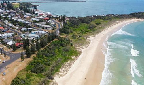 an aerial view of a beach and the ocean at La Ronde Three - Unit 3 - Oceanstays in Yamba