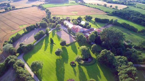 an aerial view of a farm with a house and trees at Hotel Hof Kirchhorst in Groß Wittensee