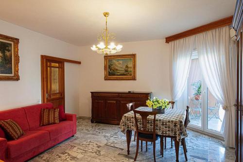 a living room with a red couch and a table at Naveen's House in Rome