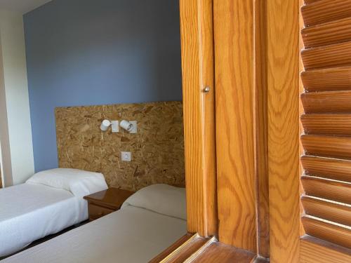 a bedroom with two beds and a wall with two towels at Apartamentos Satse Moncofa in Moncófar