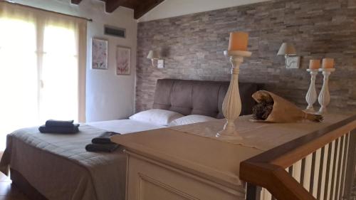 a bedroom with a bed and a brick wall at Resort il cigno in Peschiera del Garda