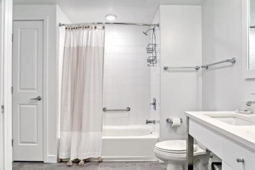 a white bathroom with a shower and a toilet at Cambridge 1BR w Gym WD nr Kendall Sq BOS-585 in Cambridge