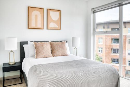 a white bedroom with a large bed and a window at Ballard 1BR w WD BBQ Gym nr Waterfront SEA-393 in Seattle