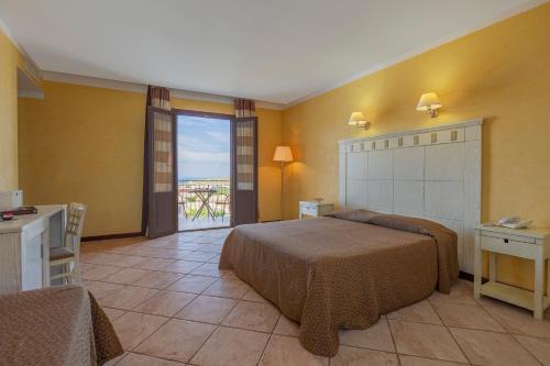 a hotel room with two beds and a balcony at Villa Zina Family Resort in Custonaci
