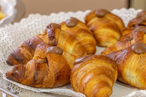 a bunch of pastries on a plate on a table at Villa Zina Family Resort in Custonaci