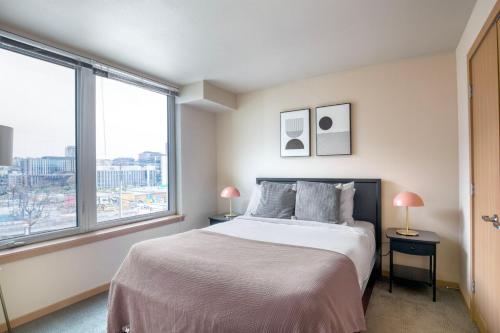 1 dormitorio con cama y ventana grande en Queen Anne 1br w gym wd lounge roof deck SEA-573 en Seattle