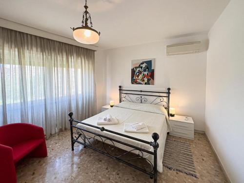 a bedroom with a bed and a red chair at Naveen's House in Rome