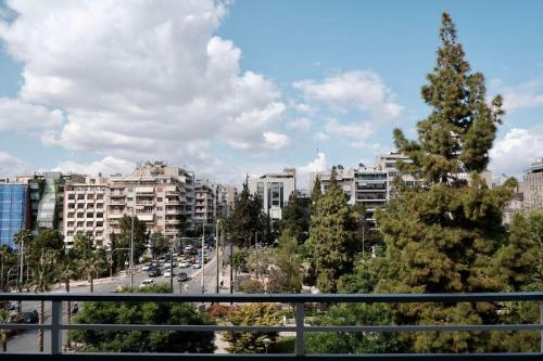 a view of a city with buildings and trees at SynPiraeus Apartments & Studios in Piraeus