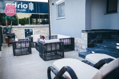 a group of chairs and tables on a patio at Adria centar Koćuša in Ljubuški
