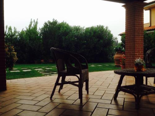 a chair and a table on a patio at Appartamenti Gli Ulivi Di Maremma in Gavorrano