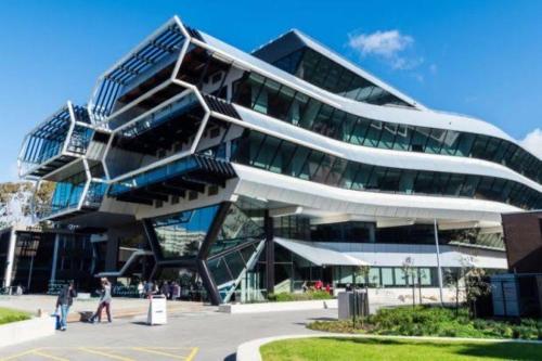 a large building with people walking in front of it at PRIVATE ROOM 2 beside Monash University, Clayton in Clayton North