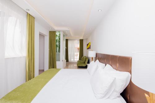 a bedroom with a large bed with white pillows at Giorgio Boutique Hotel in Sliema