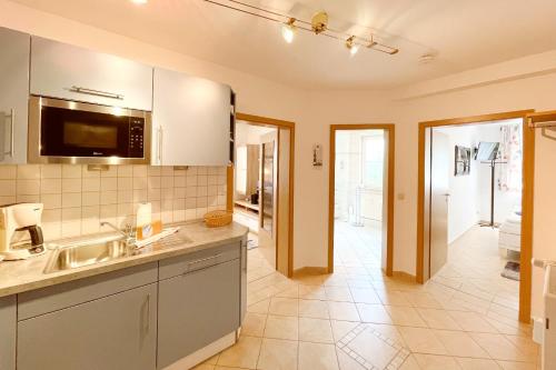 a kitchen with a sink and a counter top at Maria Gabriele Karlstrasse 6b Ferienwohnung 05 in Stubbenfelde