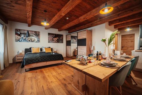 a bedroom with a bed and a table with chairs at Kocbek since 1929 in Sveti Jurij ob Ščavnici