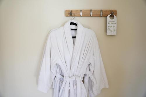 a white robe hanging on a wall at The Regent, Rye in Rye