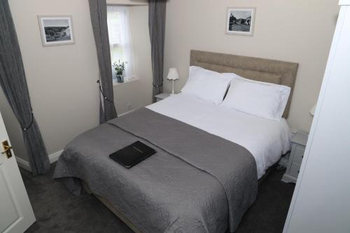 a bedroom with a bed with a book on it at Madelines Accommodation in Tinahely