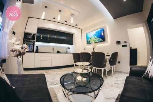 a living room with a couch and a table at Adria centar Koćuša in Ljubuški