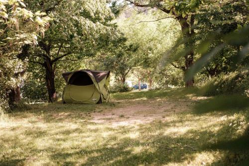 a tent in the middle of a field with trees at Slow Village Anduze - Cévennes in Corbés