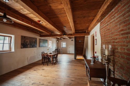 a room with a brick wall and a table and chairs at Kocbek since 1929 in Sveti Jurij ob Ščavnici