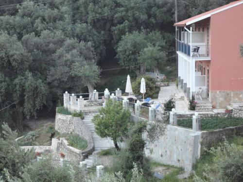 a view of a building and a wall at Stamatela Studios in Paleokastritsa