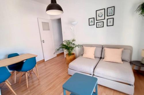 a living room with a couch and a table at Cozy one bedroom apartment in Lisbon