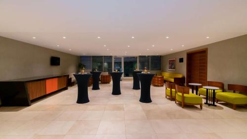 a lobby with a bar with tables and chairs at Park Inn by Radisson Istanbul Asia Kavacik in Istanbul