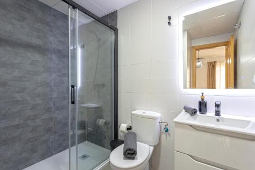 a bathroom with a shower and a toilet and a sink at LaTerraza de Ollerias in Málaga