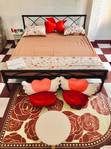 a bed with pillows and a table in a room at Dnut's House in Hanoi