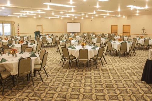 a banquet hall with tables and chairs and a whiteboard at Wingate by Wyndham Mount Vernon in Mount Vernon