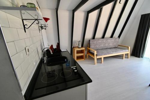 eine Küche mit einem Waschbecken und einem Stuhl in einem Zimmer in der Unterkunft Adore Datca Beach House in Döşeme