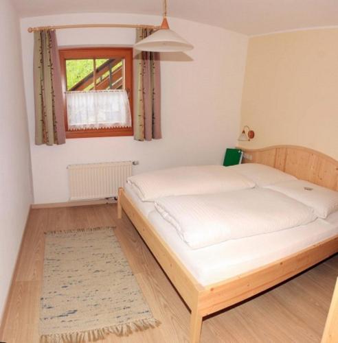 a bedroom with a large bed in a room at Schuistlhof in Sillian
