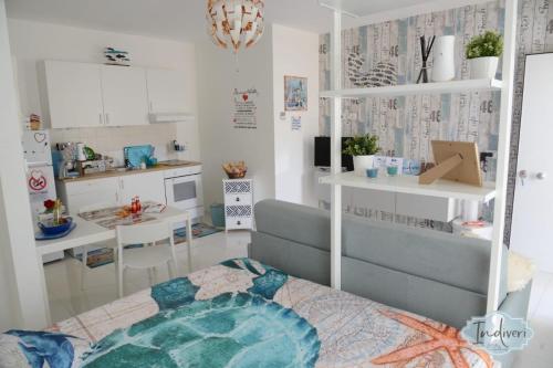 a small room with a kitchen and a table at Indiveri holiday apartaments Melissa by STHEY in Polignano a Mare