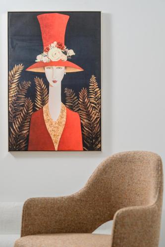 a painting of a woman wearing a red hat at Casa di Gaga Luxury Suites in Rethymno Town