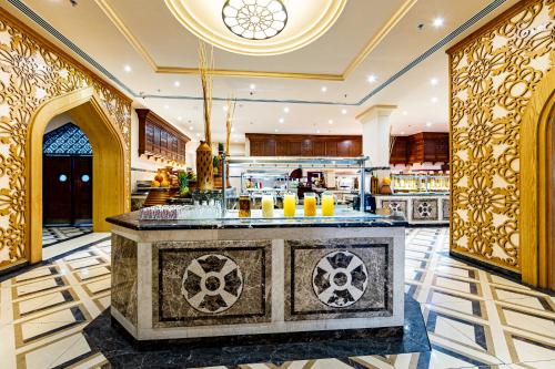 a large kitchen with a bar in a room at Grand Palace - Couples only 18 years plus in Hurghada