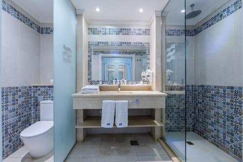 a bathroom with a sink and a toilet and a shower at Grand Palace - Couples only 18 years plus in Hurghada