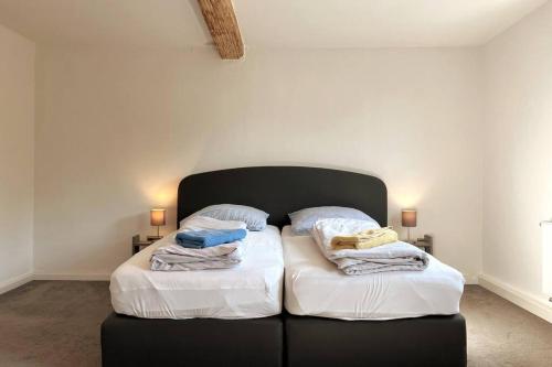 a bedroom with two beds with towels on them at Großes Ferienhaus in Singhofen in Singhofen