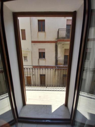 a view of a building through a window at Le Plejadi in Castellammare del Golfo